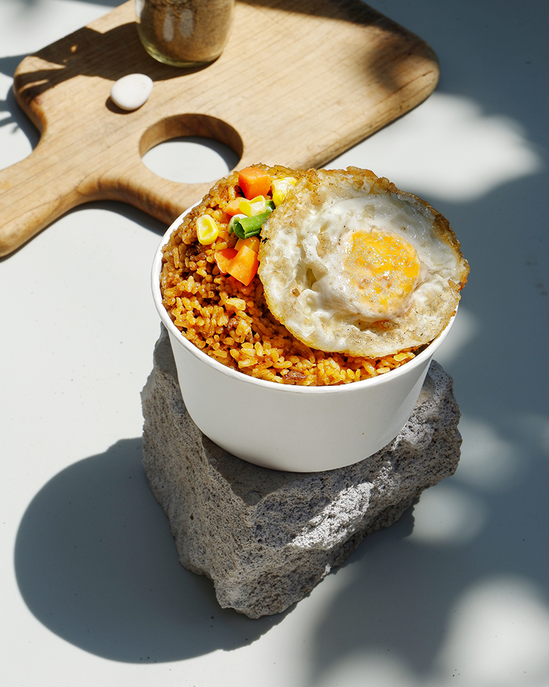 Bowl of fried rice with sunny side up egg, shot for a home business in Indonesia. PIXERF.