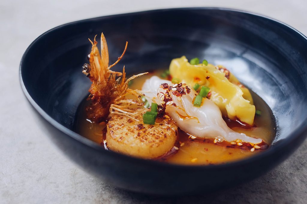 Chinese seafood dumpling soup with scallop and prawns. PIXERF.